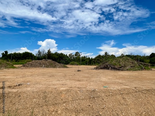 Dry open land with blue sky and clouds
