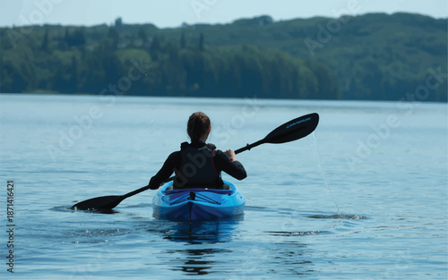 woman kayaking on a serene lake with a lush green forest in the background