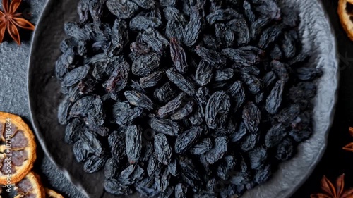 Sweet, dry black or blue raisins made from grapes are a healthy and nutritious food. Black raisins as a food background for your design