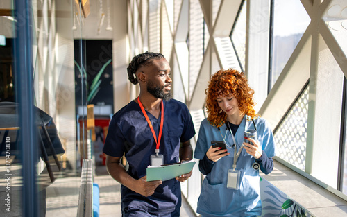 Fotografie Two young medical students talking during coffee break in hospital cafeteria