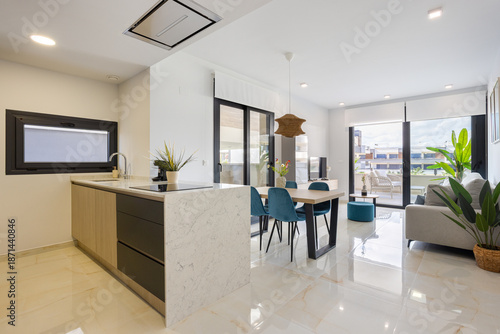 Modern open plan kitchen and living room with natural light