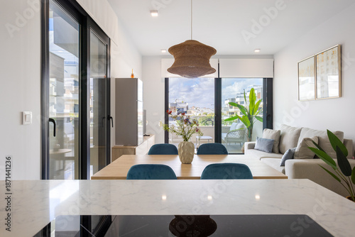 Bright modern living room with large windows and natural decor