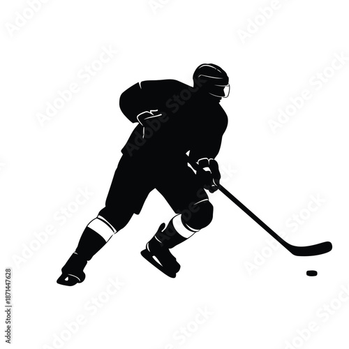 A hockey player in action, skating and hitting a puck with a stick on the ice rink from a dynamic side viewpoint