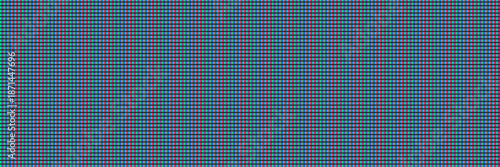 Close-up of rgb pixels on a modern liquid crystal display screen provides a vibrant abstract background texture for tech design