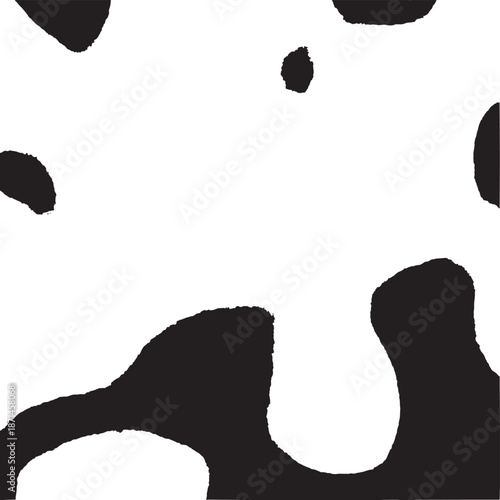 Close up of black and white cowhide pattern with irregular spots.