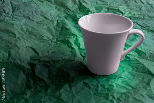 White mug on a green background
