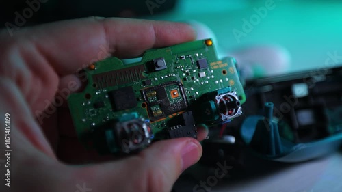 A broken game joystick in his hand.