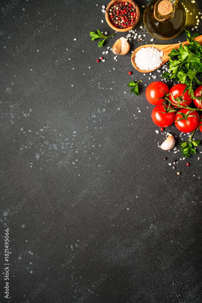 Obraz premium Food background with fresh vegetables, herbs and spices on black.