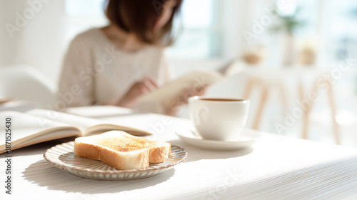 読書をしながら朝食をとる女性
