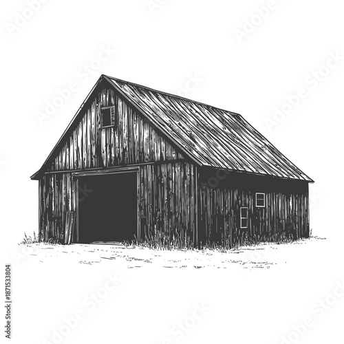 The old wooden barn stands in a field of grass