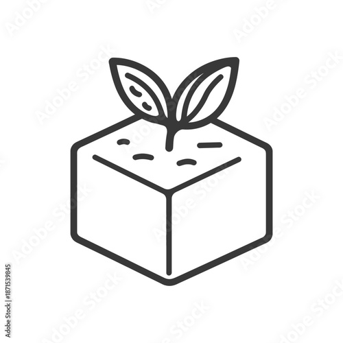 A seedling sprouts from a cubic block of soil