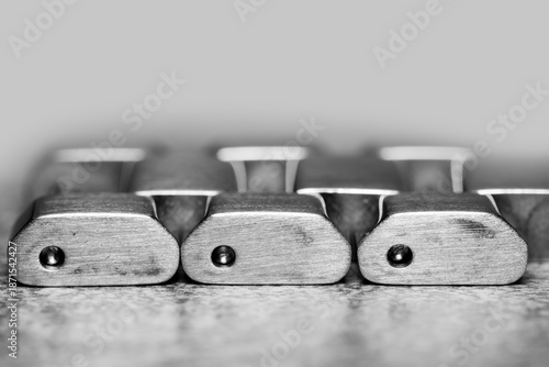 Close up view of fragment of metal stainless steel watchband with reflection, on a grey background.