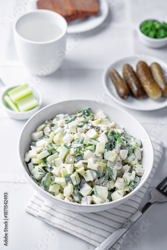 Cucumber egg mayonnaise salad in a bowl on a white background