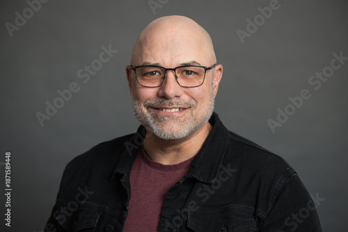 portrait of senior man with glasses, isolated on grey background