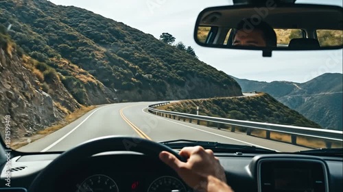 Driving a car on a winding mountain road with scenic views, first-person perspective.