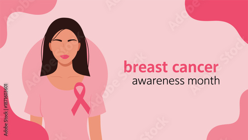 Portrait of a woman with a pink breast cancer awareness ribbon pinned to her shirt against a soft pink backdrop.