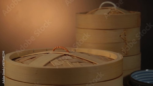 A close-up of a traditional Chinese bamboo steamer with rising steam.