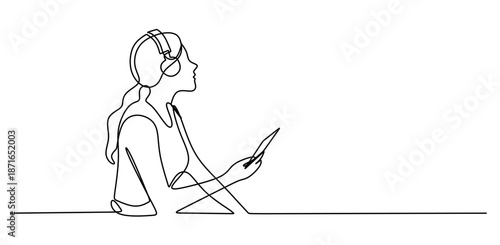 Woman sitting and listening to music on headphones in a relaxed pose