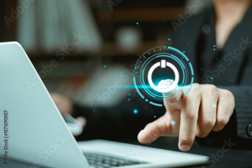 Canvas-taulu Man using laptop with pressing power button on virtual screen