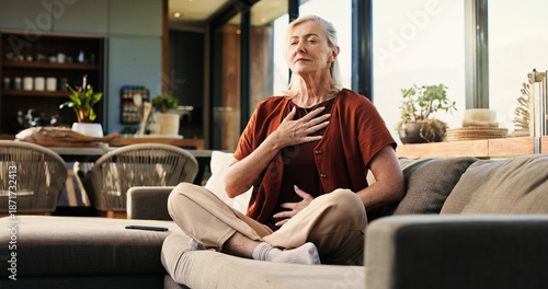 Quadro su tela Breathing, health and senior woman on sofa in home with balance, calm or zen practice in living room