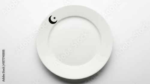 White ceramic plate with crescent moon and star design on rim isolated on plain background for food or ramadan concept with Islamic and food concept