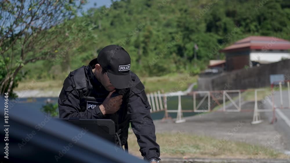 custom made wallpaper toronto digitalThe police officer is working with rugged laptop at the dam. Security, occupation.