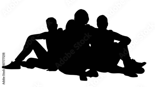 Three young men in silhouette relaxing together, sitting back to back on the ground