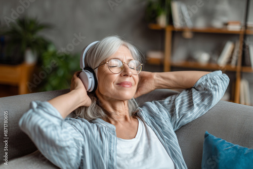 Relaxed senior woman listening to music with headphones