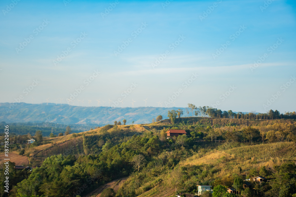 Naklejka premium Eco-Friendly Infrastructure in the Picturesque Mountains of Khao Kho, Panoramic View of Wind Turbines on a Distant Mountain Ridge