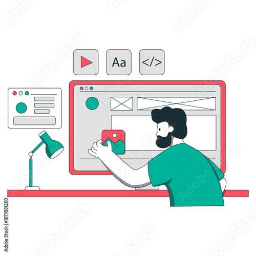 A man designs a website on a large computer screen with a green shirt and lamp.