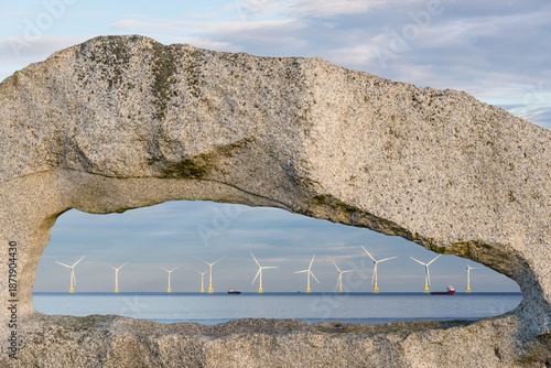 The stones known as Windows To The Sea overlook the wind turbines in the North Sea near Aberdeen, Scotland, UK