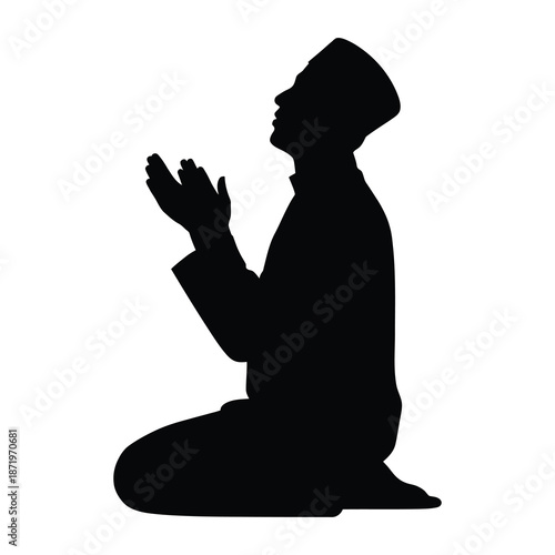 A silhouette of a man kneeling in prayer hands raised in devotion and supplication
