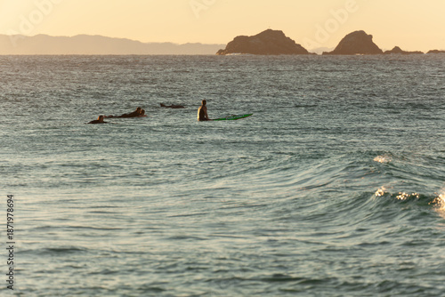 Canvastavla Evening light at Cape Byron with surfers near waves and Julian Rocks Nguthungull