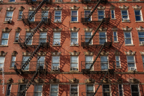 Chinatown neighborhood of Manhattan, New York City. The Fire Escapes: The black iron zig-zagging stairs on the exterior are one of the most recognizable features of New York architecture.