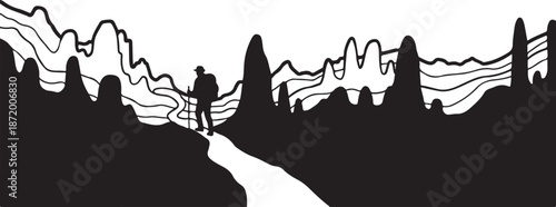 Silhouette of a person standing on a mountain path