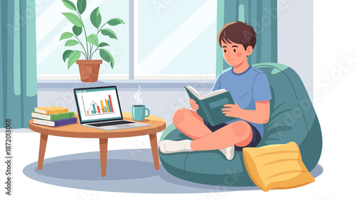 Young boy reading book on beanbag chair, laptop and plant on table