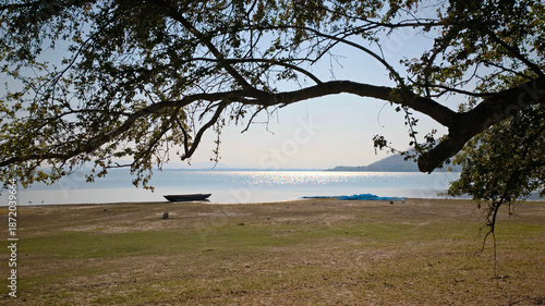 Tropical beach with a fishing boat in the foreground, Thailand