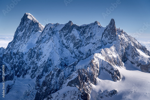 Majestic snow-capped mountain peaks on a sunny day, French Alps, Chamonix-Mont-Blanc.