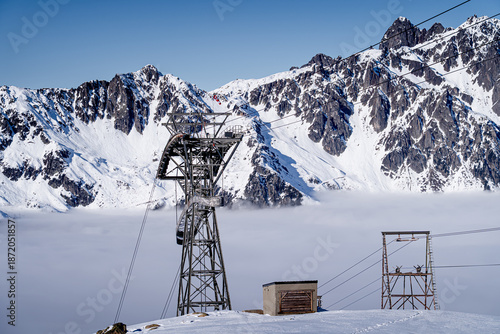 Metal structure of the Aiguille du Midi cable car station against the backdrop of snowy peaks, Alps, France, Chamonix-Mont-Blanc.