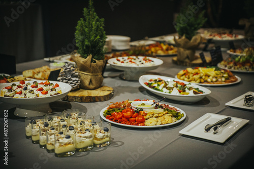 Wallpaper Mural Elegant buffet table featuring an array of gourmet dishes, including salads, appetizers, and desserts, beautifully arranged for a festive gathering with vibrant colors and textures Torontodigital.ca