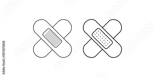 Two different sizes of adhesive medical bandages crossed over each other on white surface