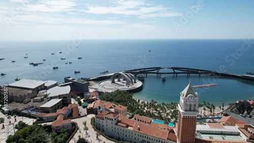 Wallpaper Mural Phu Quoc, Sunset Town, Vietnam. 4k high-quality footage taken with a Drone showcasing colorful buildings, blue skies, a watch tower, a kissing bridge, turquoise clear waters, green forest, golden sand Torontodigital.ca