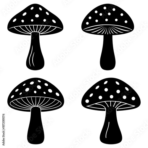 Four black and white spotted mushrooms with white dots on a transparent background