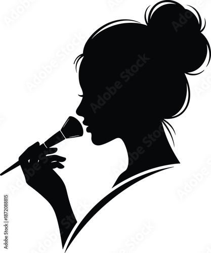 Silhouette of a beautiful woman with messy bun holding a makeup brush, elegant female profile for beauty salon logo, cosmetics branding, and spa,