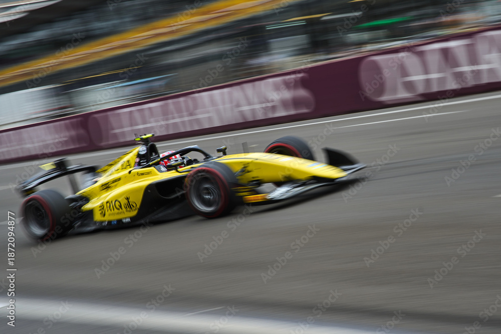 Fototapeta premium BAKU, AZERBAIJAN - SEPTEMBER 19, 2025: Invicta Racing driver Gabriel Bortoleto of Brazil competes in the Formula 2 Championship during the Azerbaijan Grand Prix weekend