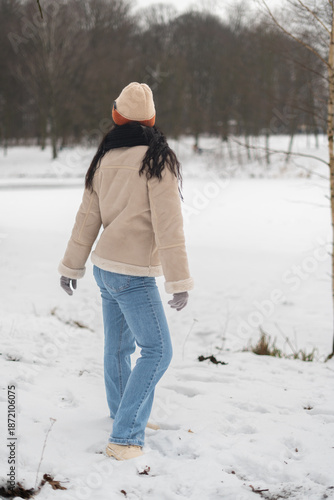 Woman walking in a snowy winter landscape