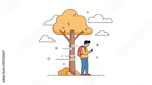 Young male enjoying autumn with smartphone under tree