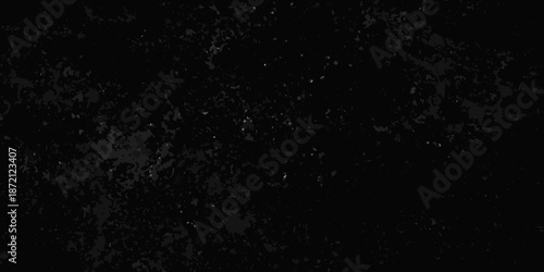 Dark grainy texture with subtle variations in shade and speckling