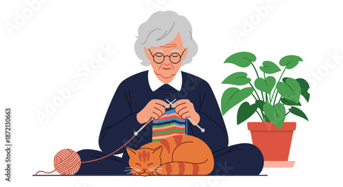 Senior woman sits cross-legged knitting a colorful scarf while a striped orange cat sleeps in her lap on a dark carpet.