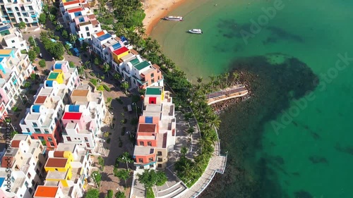 Wallpaper Mural Phu Quoc, Sunset Town, Vietnam. 4k high-quality footage taken with a Drone showcasing colorful buildings, blue skies, a watch tower, a kissing bridge, turquoise clear waters, green forest, golden sand Torontodigital.ca
